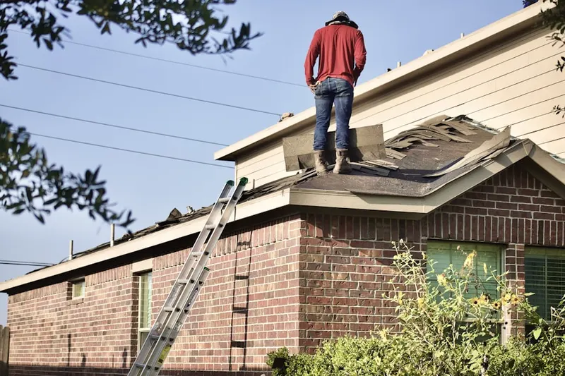 Professional roofer working on a residential roof in Villas at Golf View Estates